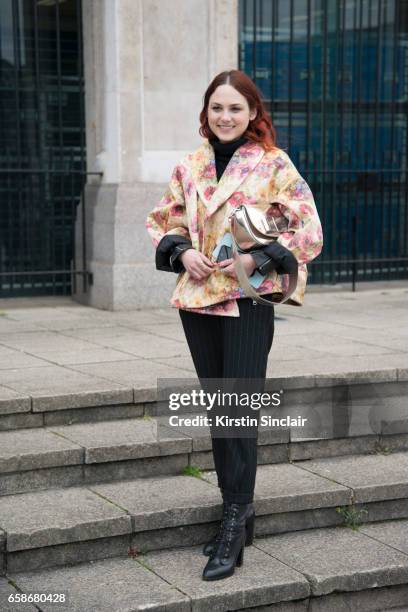 Guest wears a Floral jacket and Metallic bag on day 3 of London Womens Fashion Week Autumn/Winter 2017, on February 19, 2017 in London, England.