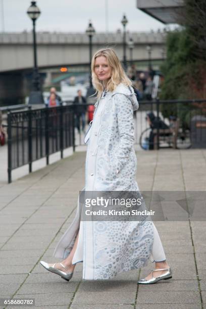 Model and Photographer Candice Lake wears a Peter Pilotto coat and dress, Jimmy Choo bag and Camilla Elphick shoes on day 3 of London Womens Fashion...