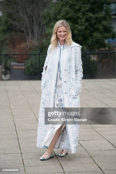 Model and Photographer Candice Lake wears a Peter Pilotto coat and dress, Jimmy Choo bag and Camilla Elphick shoes on day 3 of London Womens Fashion...