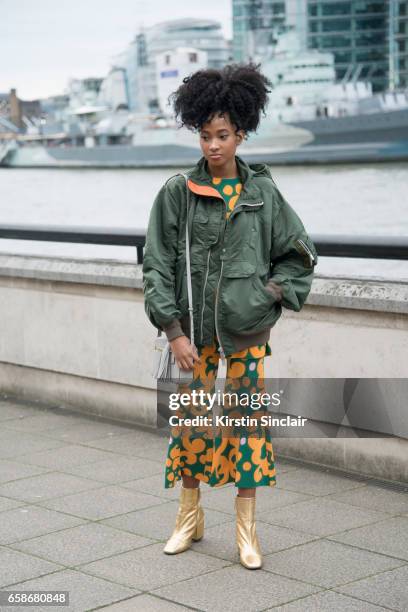 Social Media manager and editor for Barneys New York Candace Marie wears Mango boots, Sacai bomber jacket, Anya Hindmarch bag and a Marimekko top and...