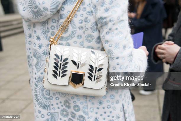 Model and Photographer Candice Lake wears a Peter Pilotto coat and Jimmy Choo bag on day 3 of London Womens Fashion Week Autumn/Winter 2017, on...