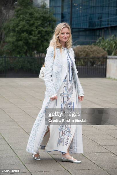 Model and Photographer Candice Lake wears a Peter Pilotto coat and dress, Jimmy Choo bag and Camilla Elphick shoes on day 3 of London Womens Fashion...