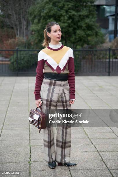 Fashion blogger Irina Lakicevic wears Celine trousers and boots, Mulberry bag and sweater on day 3 of London Womens Fashion Week Autumn/Winter 2017,...