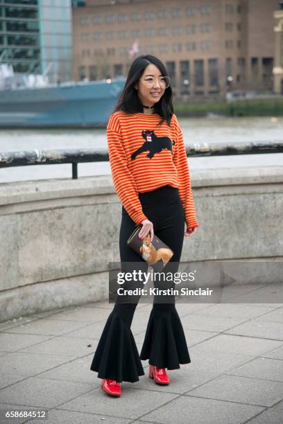 Fashion blogger YuYu Zhangzou wears a Gucci sweater, Away Lee trousers, Mulberry bag, Jinnn glasses and Dorateymur shoes on day 3 of London Womens...