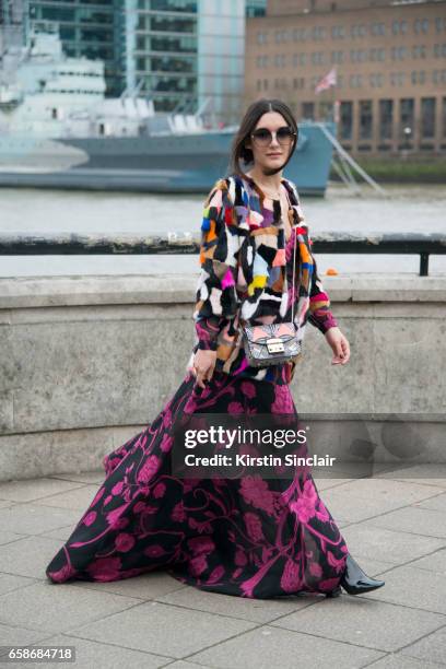 Fashion blogger Anisa Sojka wears a Jane and Tash jacket, New Look boots, Matthew Williamson dress and sunglasses and a Furla bag on day 3 of London...