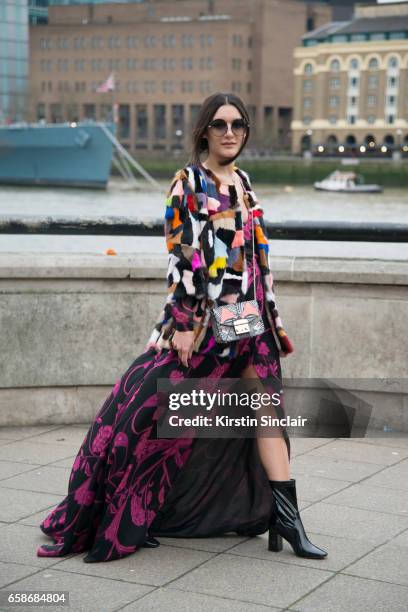 Fashion blogger Anisa Sojka wears a Jane and Tash jacket, New Look boots, Matthew Williamson dress and sunglasses and a Furla bag on day 3 of London...