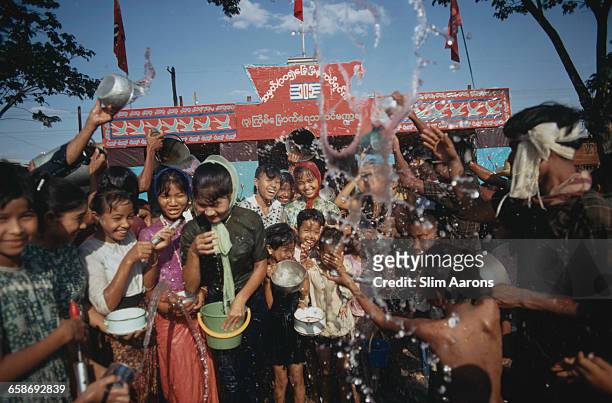 Revellers enjoying a water fight during the New Year Thingyan Water Festival in Bago , Myanmar , May 1971.