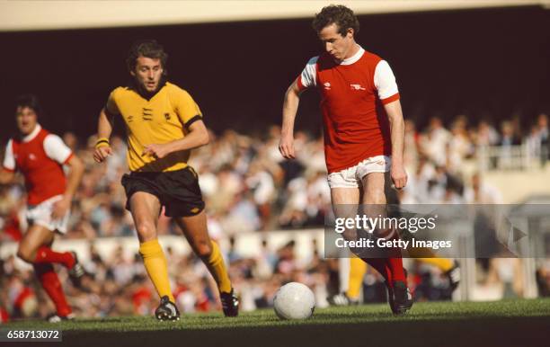 Liam Brady of Arsenal in action watched by Peter Daniel of Wolves during a First Division Match at Highbury on September 29, 1979 in London, England.