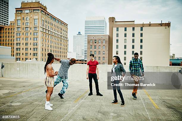 group of friends watching man dance on rooftop - memphis tennessee stock pictures, royalty-free photos & images