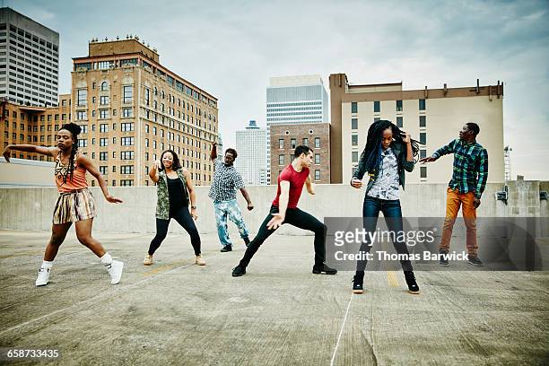 group of friend dancing on rooftop - tipo di danza foto e immagini stock