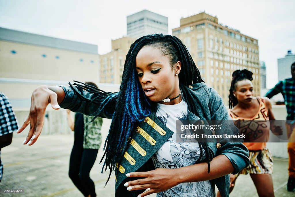 Woman dancing with friends on rooftop