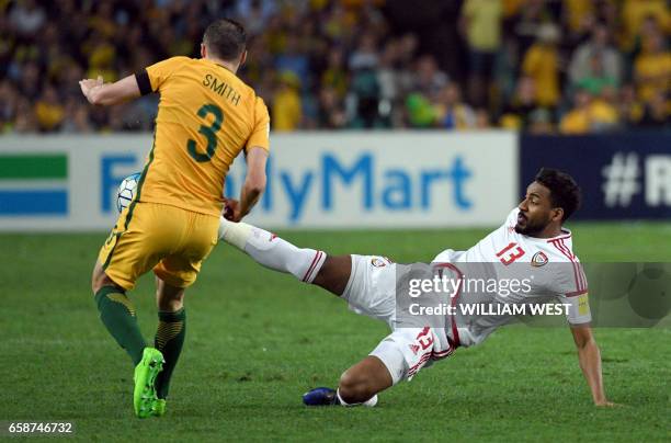 Australia's Brad Smith is tackled by United Arab Emirates player Khamis Esmaeel in their World Cup qualifying football match in Sydney on March 28,...