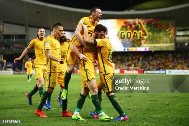 Mathew Leckie of the Socceroos celebrates with team mates after scoring the second goal during the 2018 FIFA World Cup Qualifier match between the...