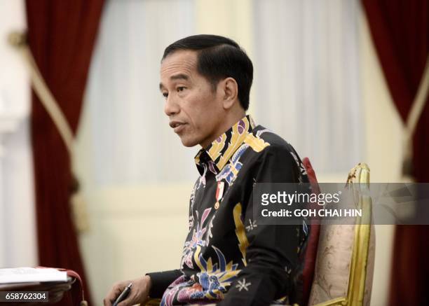 This picture taken on March 27, 2017 shows Indonesian President Joko Widodo reacting to a question during an exclusive interview with AFP at the...