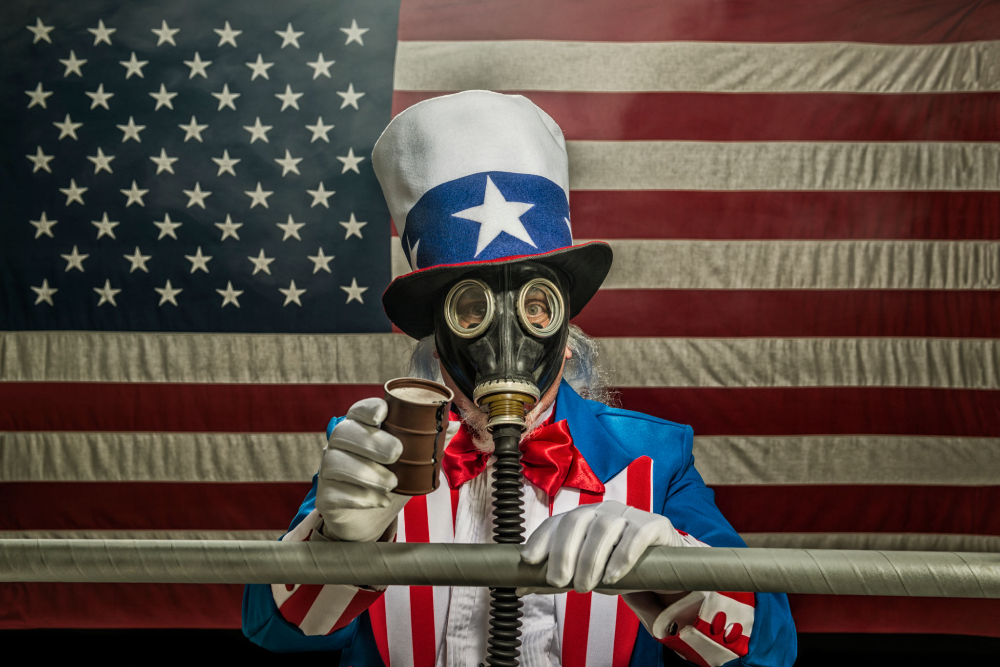 Uncle Sam wearing gas mask holding oil drum and pipe line Uncle Sam wearing gas mask holding oil drum and pipe line