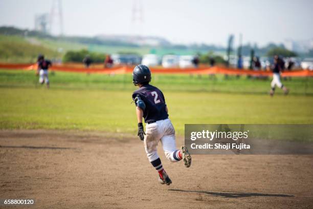 youth baseball players, base-running - baseball tee stock pictures, royalty-free photos & images