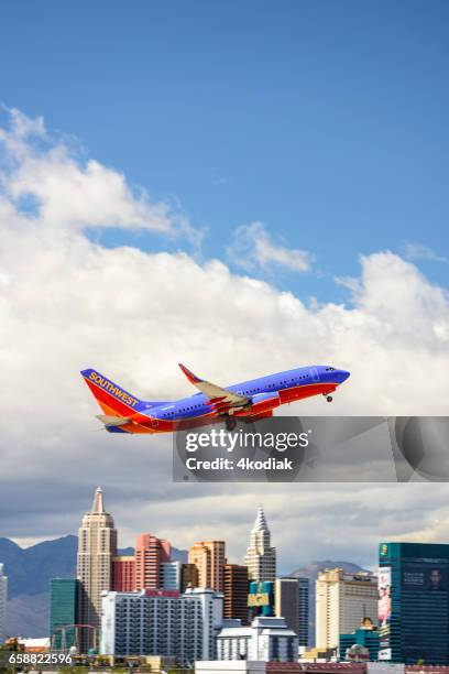 las vegas hotel casino buildings with airplane taking off. - southwest stock pictures, royalty-free photos & images
