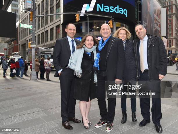 Fashion designer Carmen Marc Valvo and Michael's Mission pose outside NASDAQ after ringing the Nasdaq Stock Market Opening Bell at NASDAQ on March...