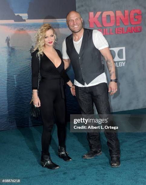 Actress Mindy Robinson and fighter Randy Couture arrive for the Premiere Of Warner Bros. Pictures' "Kong: Skull Island" held at Dolby Theatre on...