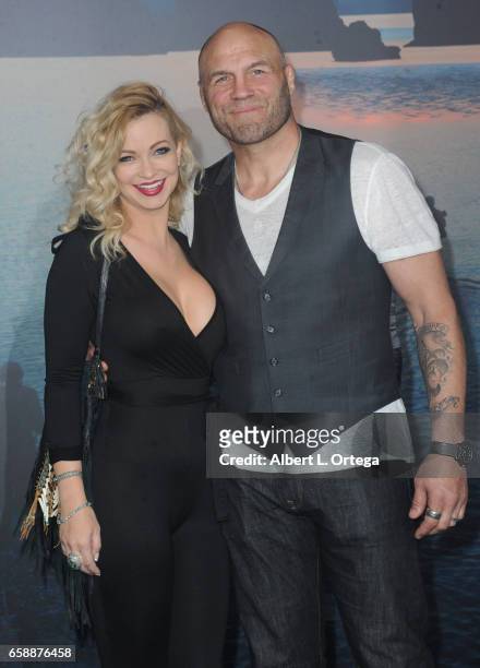 Actress Mindy Robinson and actor/fighter Randy Couture arrive for the Premiere Of Warner Bros. Pictures' "Kong: Skull Island" held at Dolby Theatre...