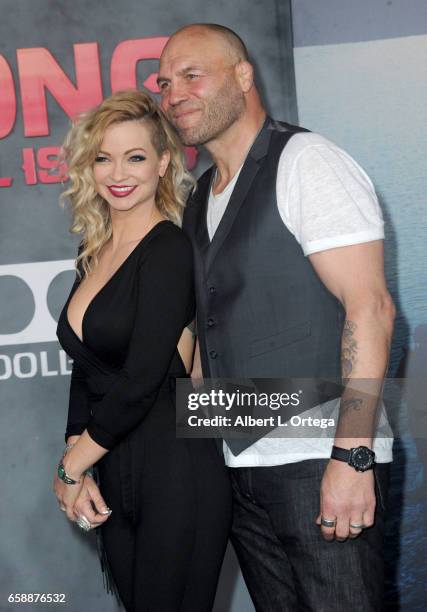 Actress Mindy Robinson and actor/fighter Randy Couture arrive for the Premiere Of Warner Bros. Pictures' "Kong: Skull Island" held at Dolby Theatre...