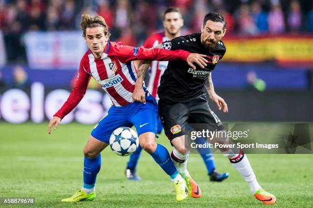 Antoine Griezmann of Atletico de Madrid fights for the ball with Roberto Hilbert of Bayer 04 Leverkusen during their 2016-17 UEFA Champions League...