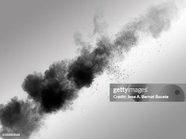 explosion of a cloud of powder of particles of  colors gray on a white background - fondo gris imagens e fotografias de stock