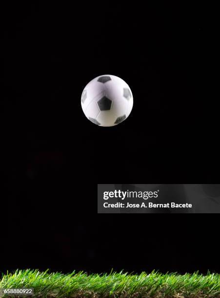 ball of  soccer ball bouncing on a surface of  grass of a soccer field - césped stock pictures, royalty-free photos & images