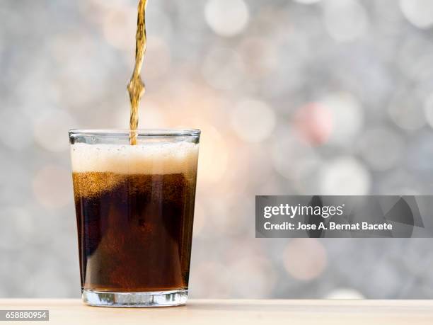 filling of one glass of refreshment of tail , illuminated with natural light - refresco stock pictures, royalty-free photos & images