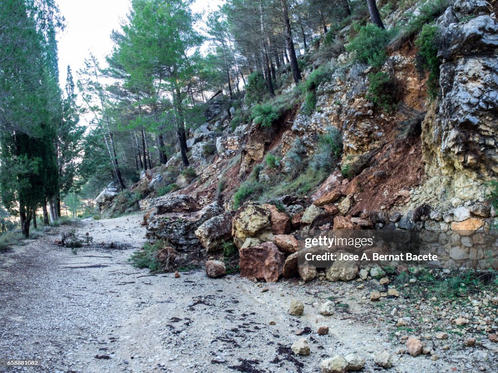Road of mountain cut by a landslide of rocks and mud for the strong rains