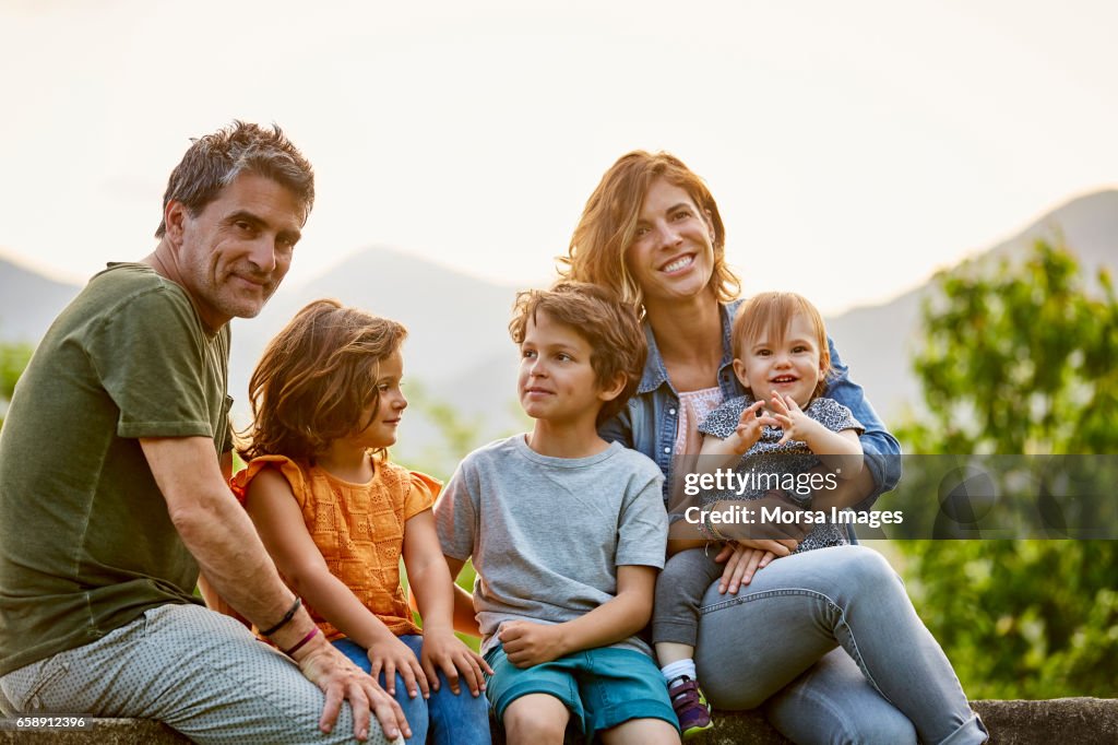 Portrait of happy parents with children in yard