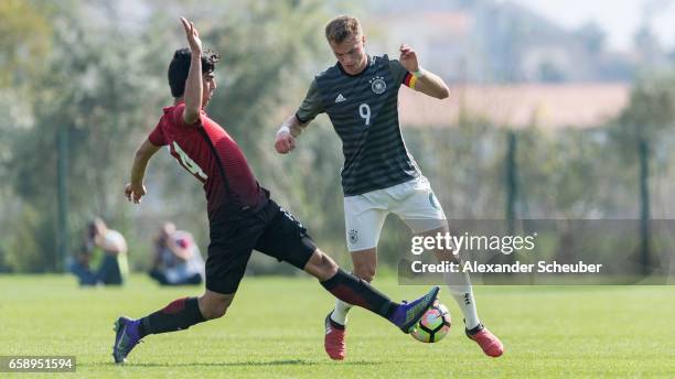 Berkehan Bicer of Turkey challenges Jann-Fiete Arp of Germany during the UEFA U17 elite round match between Germany and Turkey on March 28, 2017 in...