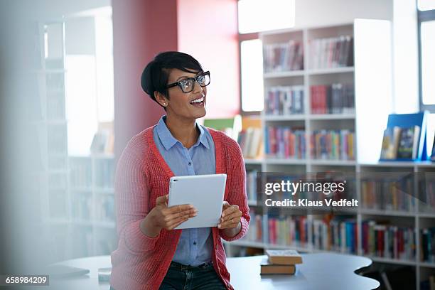 teacher talking to students, in the library - education occupation stock pictures, royalty-free photos & images