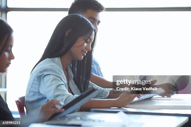 students looking at tablets in classroom - 2 sides stock pictures, royalty-free photos & images