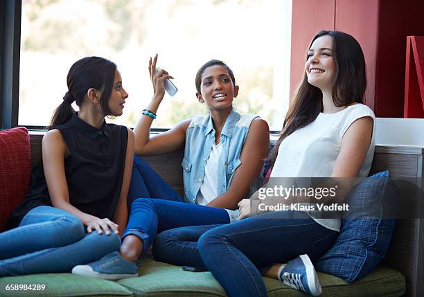 girlfriends talking & laughing at school - college girl pics ストックフォトと画像