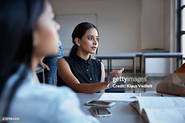 students listening to co-student in group - girl desk stock pictures, royalty-free photos & images