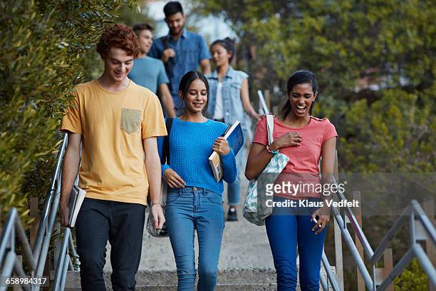 friends walking down stairs after school - community college campus stock pictures, royalty-free photos & images