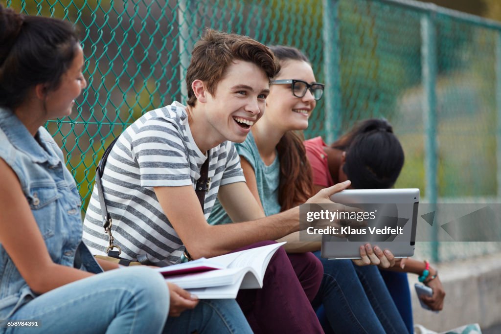 Friends laughing together at school