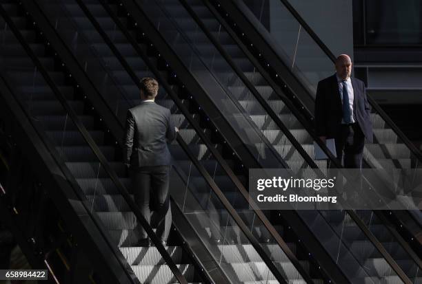 Businessmen use a set of escalators at the Leadenhall Building in London, U.K., on Tuesday, March 28, 2017. London has retained the mantle as the...