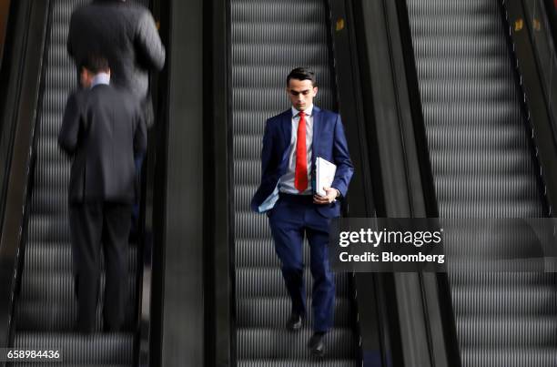 Businessmen use a set of escalators at the Leadenhall Building in London, U.K., on Tuesday, March 28, 2017. London has retained the mantle as the...