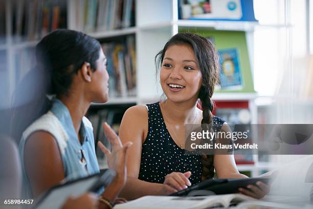 female student listening to co-student - asian girl photos et images de collection