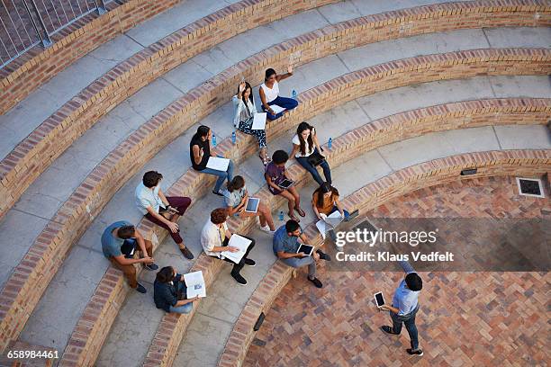 students having class in outside auditorium - university foto e immagini stock