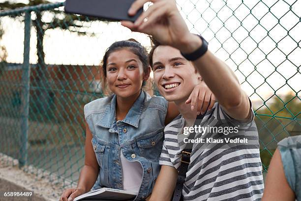 friends making selfie outside school - couple bonding stock pictures, royalty-free photos & images