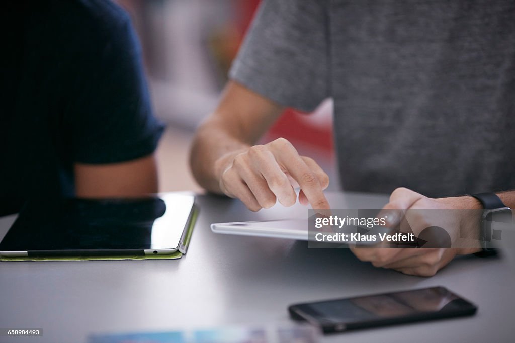 Close-up of student scrolling on tablet