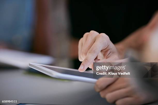 close-up of student scrolling on tablet - differential focus education stock pictures, royalty-free photos & images