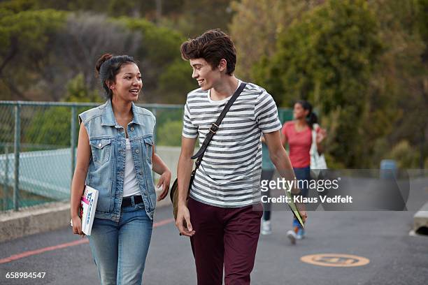 friends walking to school together & laughing - pojkvän bildbanksfoton och bilder