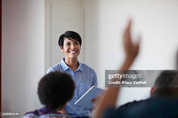 teacher in front of student, raised hand - school tablet stockfoto's en -beelden