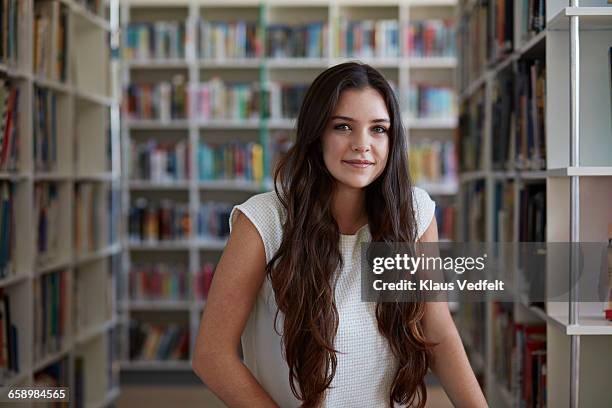 portrait of female student in library - girl long hair stock pictures, royalty-free photos & images
