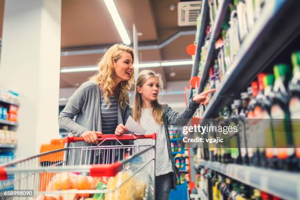 mother and daughter in a supermarket - child pointing stock pictures, royalty-free photos & images