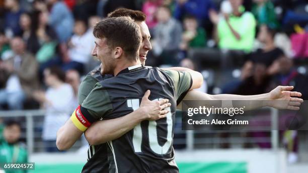 Salih Oezcan of Germany celebrates his team's second goal with team mate Dominik Franke during the UEFA Elite Round match between Germany U19 and...